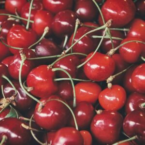 A vivid close-up of fresh cherries displaying their natural shine and rich red colors.